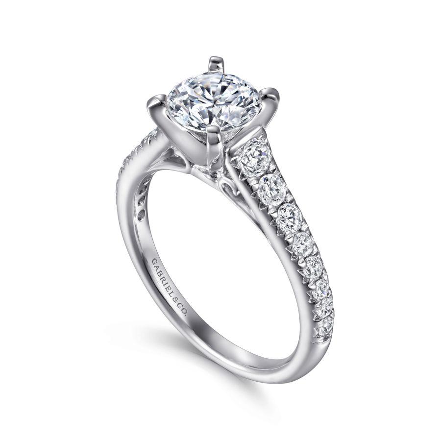 14kw .53ct Dia Semi-Mount    This 14K white gold contemporary engagement ring has a classic look with its straight styled band. The band showcases the gorgeous graduating diamonds leading to the main star of the show  the round center stone.